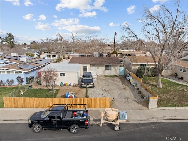 ranch-style house with a fenced front yard and a residential view