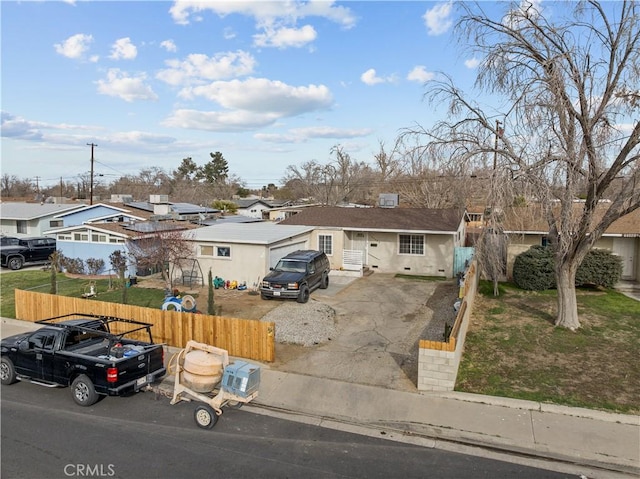 single story home featuring a residential view and fence