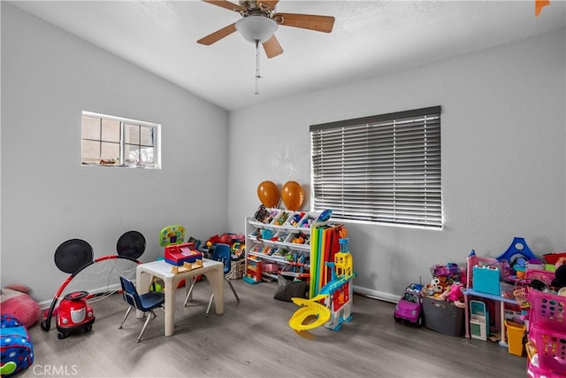 playroom featuring ceiling fan and wood finished floors