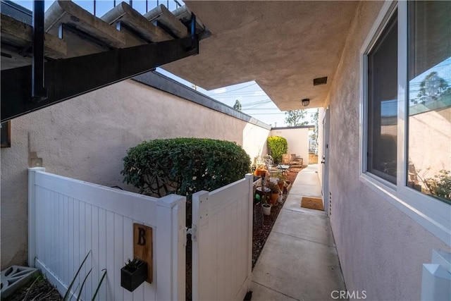 view of home's exterior with fence and stucco siding