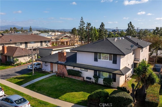 view of front of property with a residential view and a front lawn