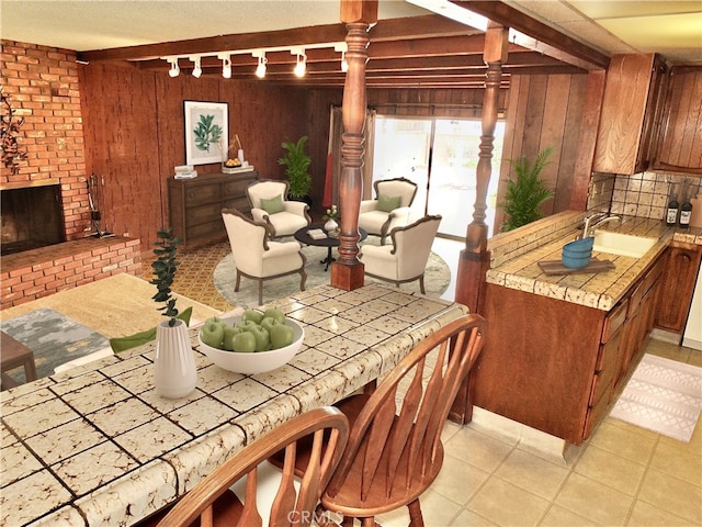 dining area with wooden walls and a fireplace