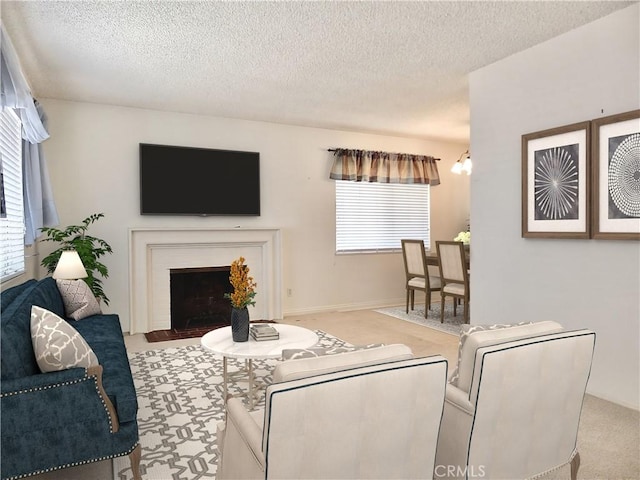 carpeted living room with a fireplace with flush hearth, a wealth of natural light, and a textured ceiling