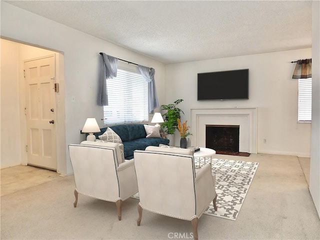 living room with a fireplace with flush hearth, light colored carpet, and a textured ceiling