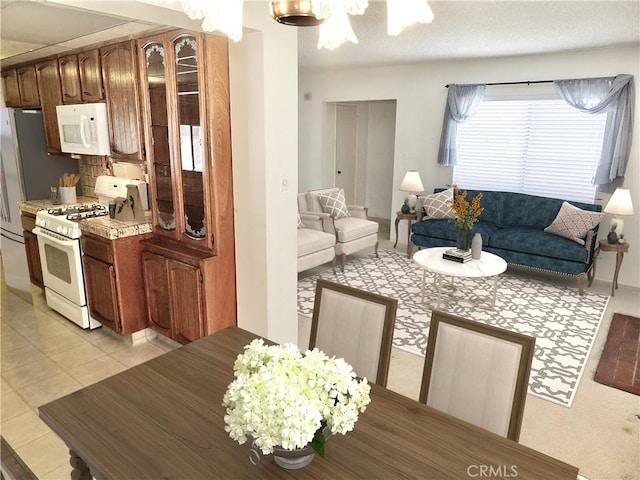 dining area featuring light tile patterned floors and an inviting chandelier