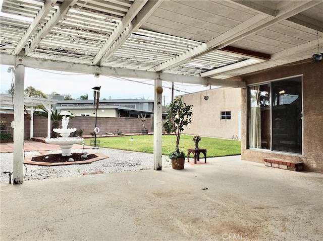 view of patio with a pergola and fence