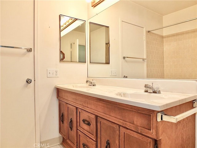 full bathroom with double vanity and a sink