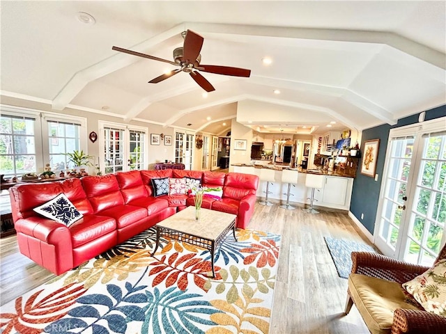 living room with french doors, lofted ceiling, ceiling fan, light wood-type flooring, and baseboards