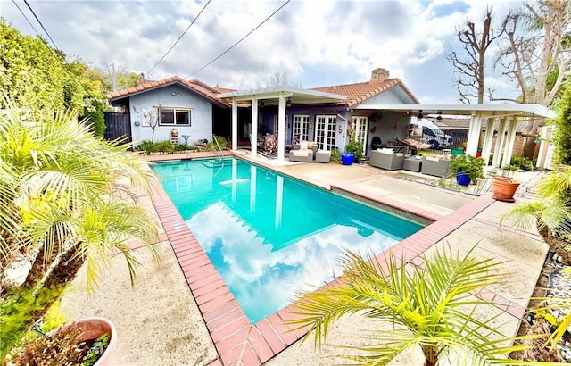 outdoor pool featuring french doors, ceiling fan, an outdoor living space, and a patio