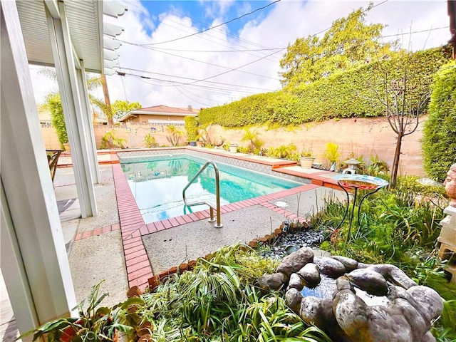 view of swimming pool featuring a fenced backyard and a fenced in pool