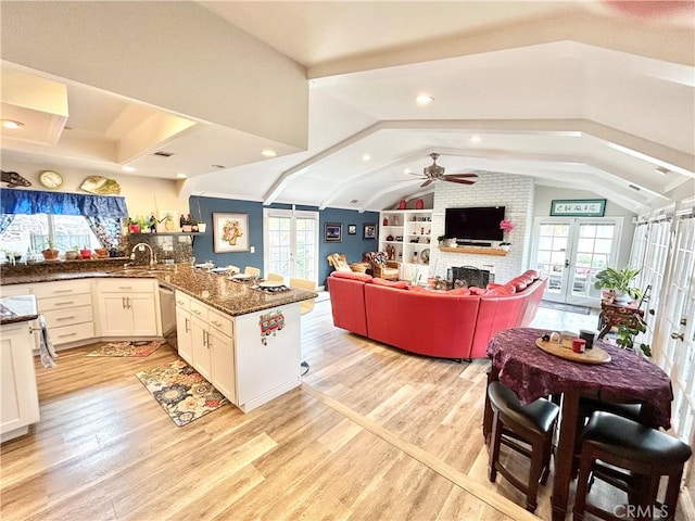 kitchen featuring plenty of natural light, light wood-style flooring, a sink, and french doors