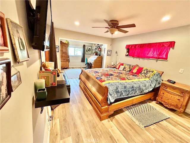 bedroom featuring wood finished floors, a ceiling fan, and recessed lighting