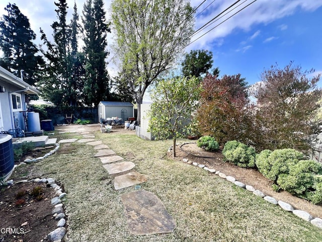 view of yard with a storage shed, cooling unit, and an outdoor structure