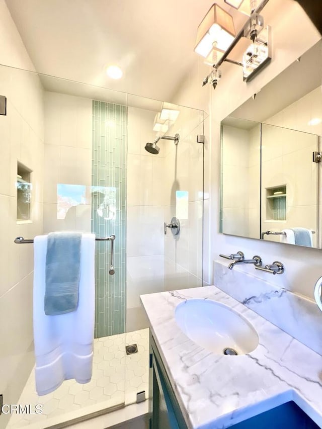 full bath with vanity and a shower stall