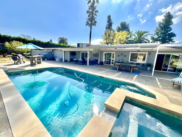 outdoor pool with a patio, outdoor dining area, and outdoor lounge area