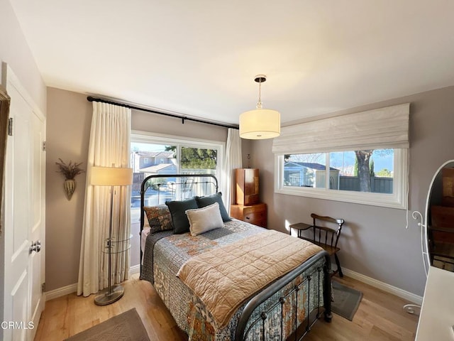 bedroom featuring wood finished floors and baseboards