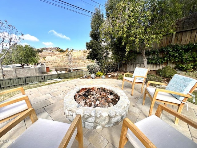 view of patio / terrace with an outdoor fire pit and a fenced backyard