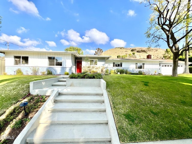 ranch-style home featuring a front yard