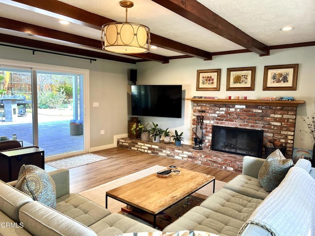 living area featuring recessed lighting, a fireplace, wood finished floors, baseboards, and beamed ceiling