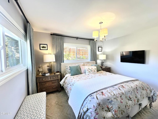 bedroom featuring carpet floors and an inviting chandelier