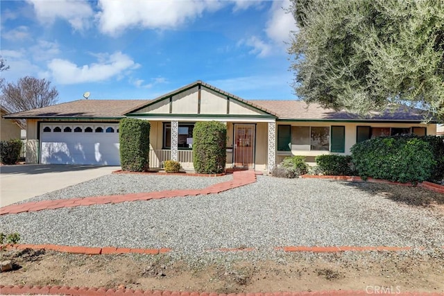 single story home with driveway, an attached garage, a porch, and stucco siding