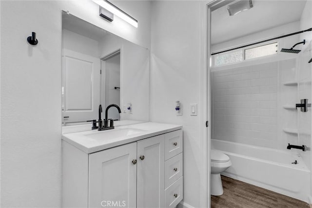 full bath featuring visible vents, toilet, wood finished floors, vanity, and shower / bathing tub combination