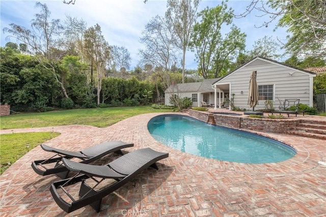 pool featuring a lawn and a patio