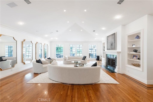 4471 Woodley Ave, Encino, CA 91436 - living room featuring built in features, wood finished floors, baseboards, a fireplace, and vaulted ceiling