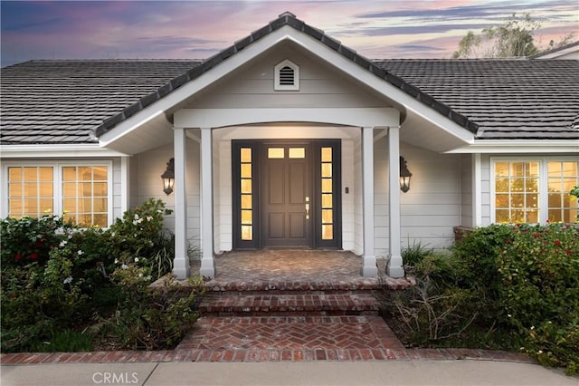 view of exterior entry at dusk