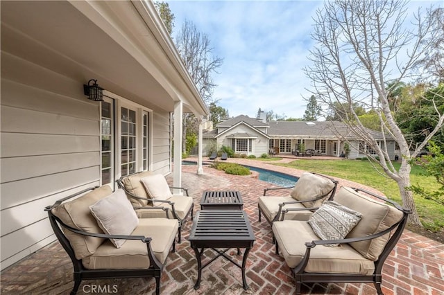 view of patio / terrace featuring an outdoor pool and an outdoor living space