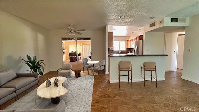 28821 Del Monte Dr, Menifee, CA 92586 - living area featuring ceiling fan and a textured ceiling