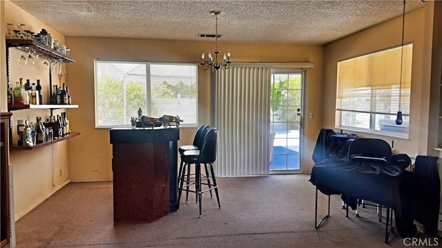 28821 Del Monte Dr, Menifee, CA 92586 - carpeted dining space featuring a bar, a textured ceiling, and a chandelier