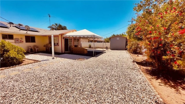 28821 Del Monte Dr, Menifee, CA 92586 - view of yard featuring a storage unit and a patio area