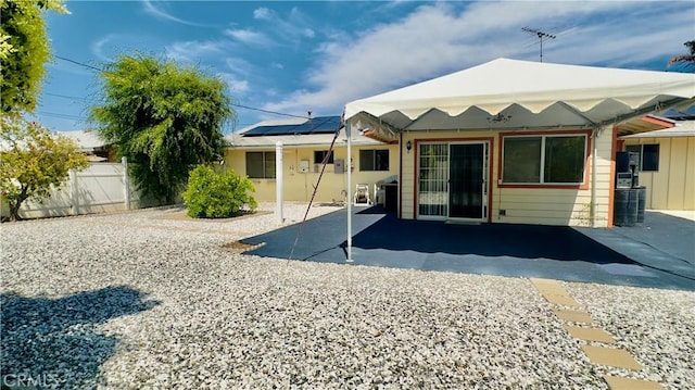28821 Del Monte Dr, Menifee, CA 92586 - back of house with roof mounted solar panels and a patio area