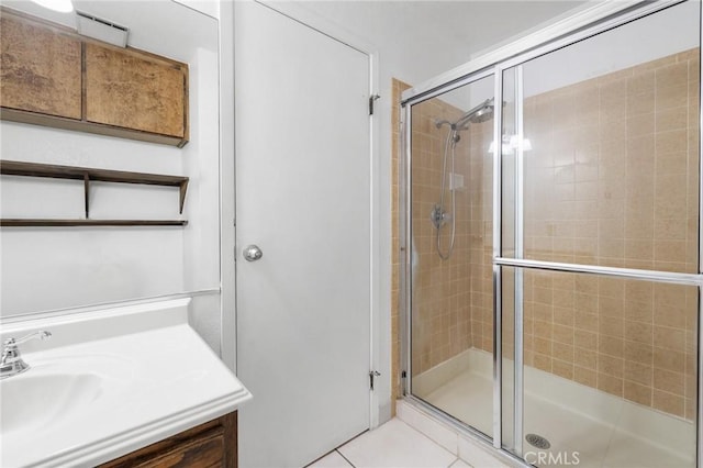 13615 Spring Valley Pkwy, Victorville, CA 92395 - bathroom with tile patterned flooring, a shower stall, and vanity