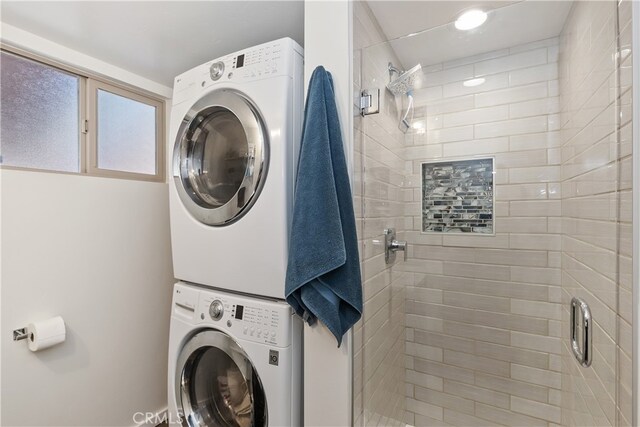 clothes washing area with laundry area and stacked washer / drying machine