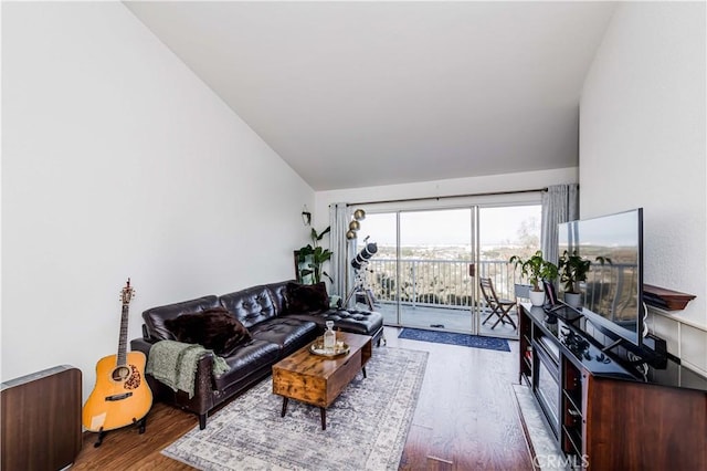 living room with lofted ceiling and wood finished floors