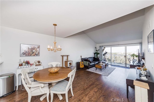 dining room featuring lofted ceiling, a chandelier, and wood finished floors