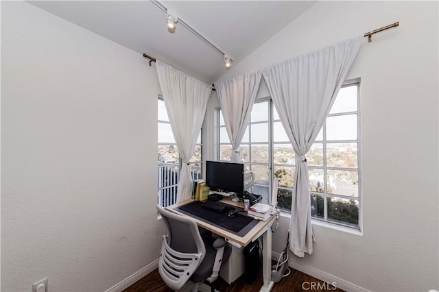 office area with vaulted ceiling, wood finished floors, rail lighting, and baseboards