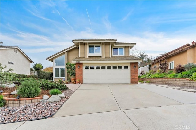 view of front of house with driveway, brick siding, and an attached garage