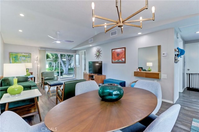 dining room featuring lofted ceiling, wood finished floors, and visible vents