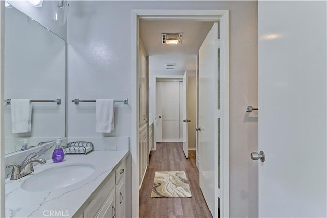 bathroom with visible vents, wood finished floors, and vanity