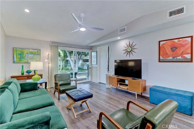 living room with lofted ceiling, visible vents, ceiling fan, and wood finished floors