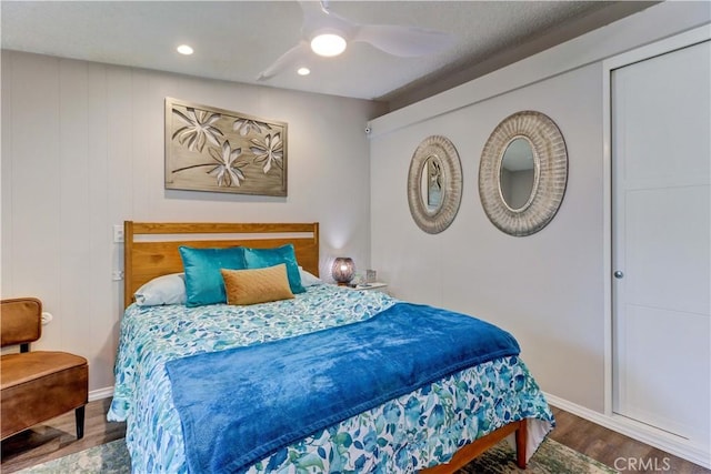 bedroom featuring wood finished floors, a ceiling fan, and recessed lighting