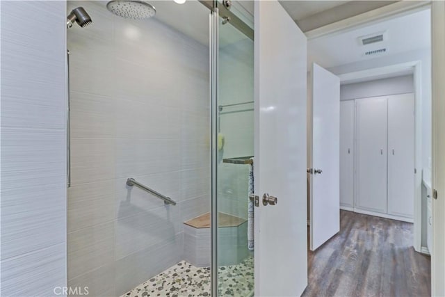 bathroom featuring a stall shower and wood finished floors