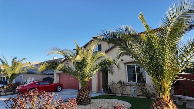 obstructed view of property featuring an attached garage, driveway, and stucco siding