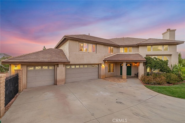 41445 Terrazzo Dr, Palmdale, CA 93551 - view of front of home with concrete driveway, a chimney, stucco siding, and a garage