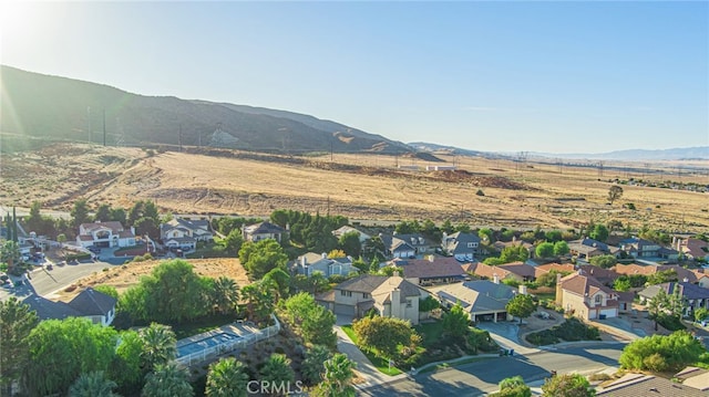 drone / aerial view featuring a residential view and a mountain view