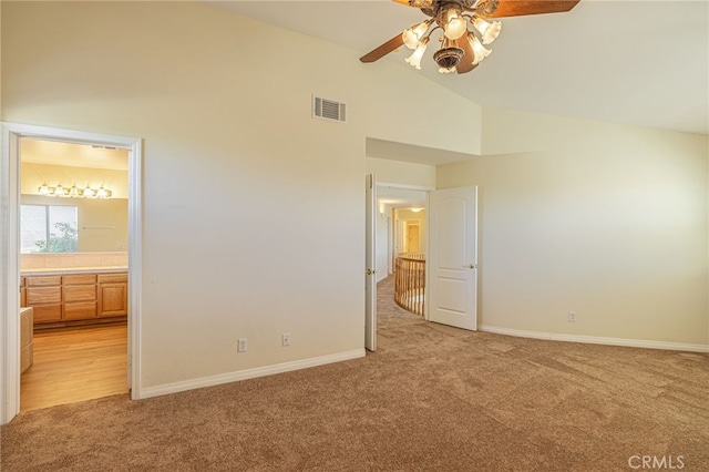 unfurnished bedroom featuring light carpet, ensuite bathroom, visible vents, and baseboards