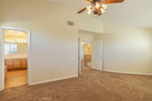 41445 Terrazzo Dr, Palmdale, CA 93551 - unfurnished bedroom with light carpet, lofted ceiling, baseboards, ensuite bath, and ceiling fan